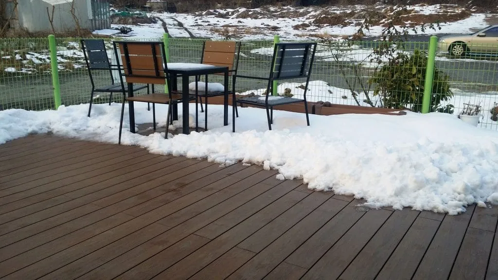 Outdoor dining set on a snow-dusted deck