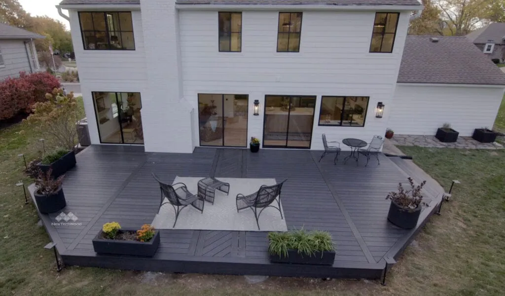 Dark boards on a patio beneath a modern house
