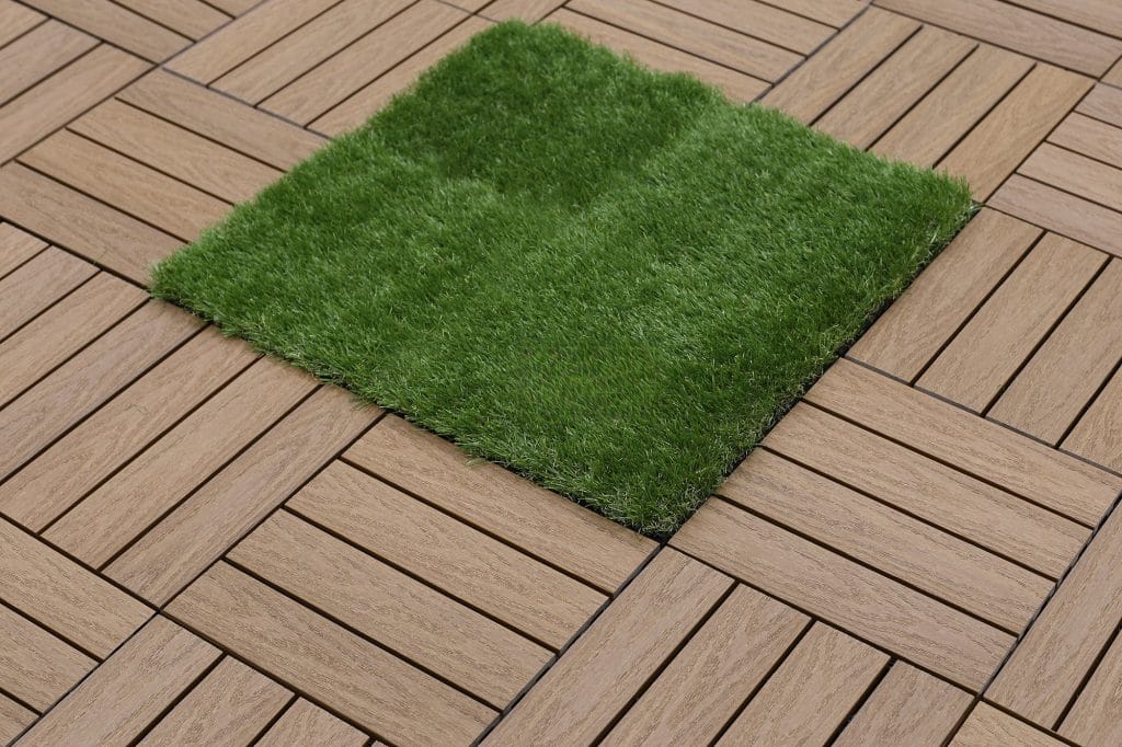 Deck tiles laid around an artificial-turf inset