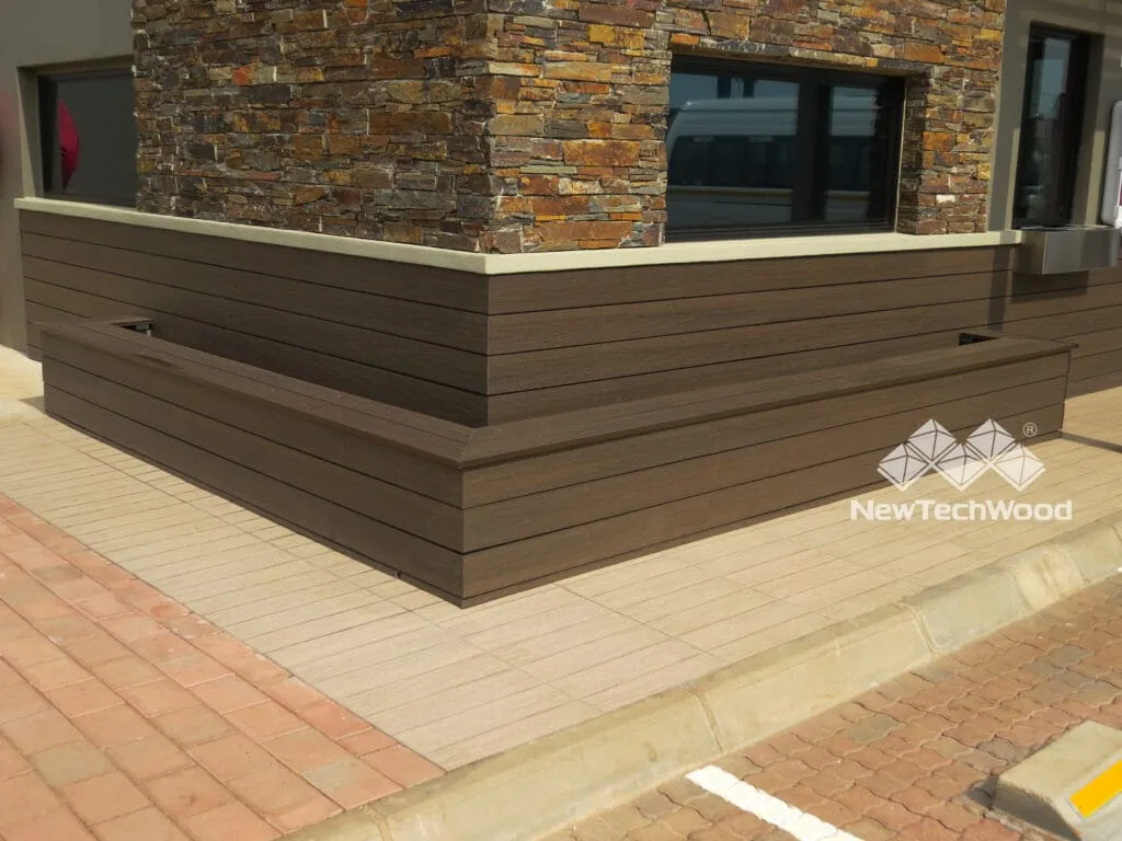 Composite cladding above a stone base