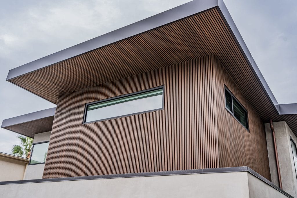 Slatted facade under a clear sky