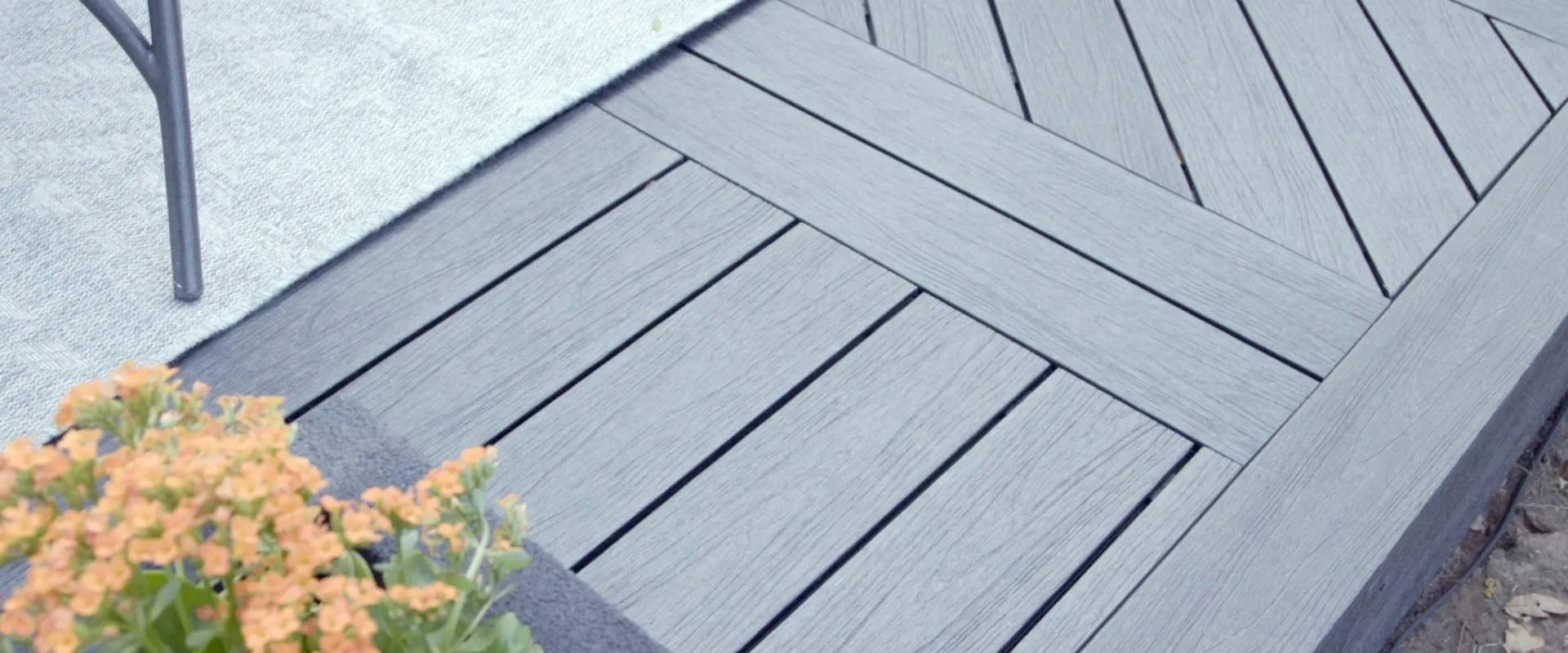 Herringbone composite decking detail in weathered gray