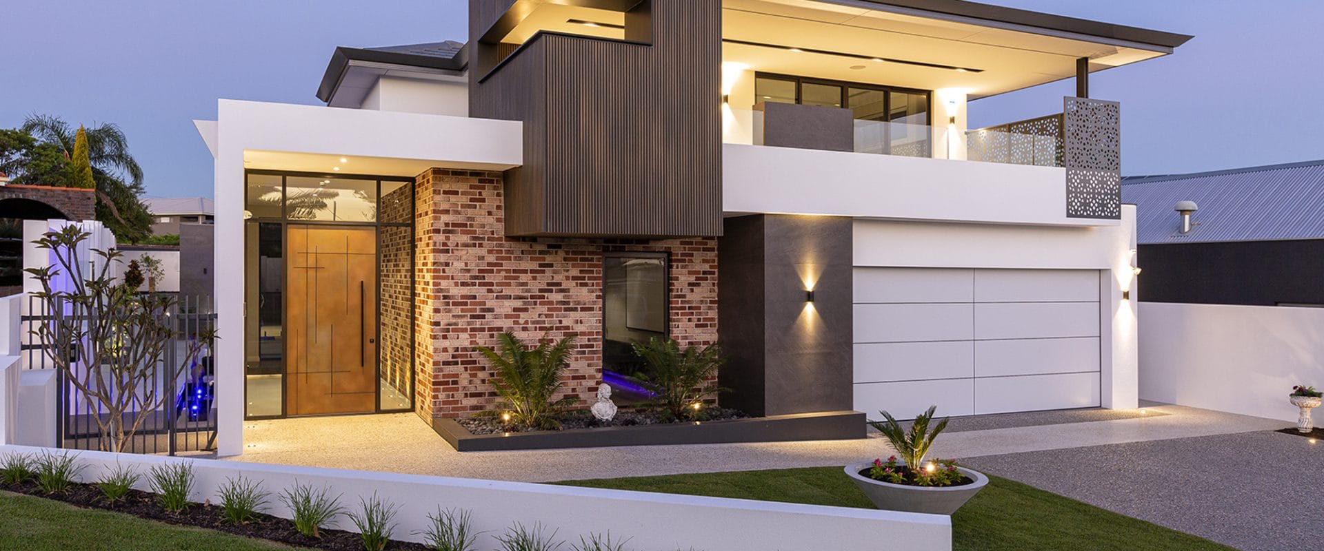 Modern residence at dusk clad in NewTechWood composite siding